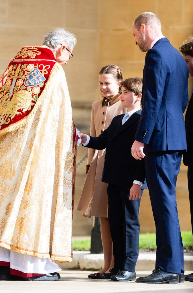Prince Louis of Wales shaking bishop's hand