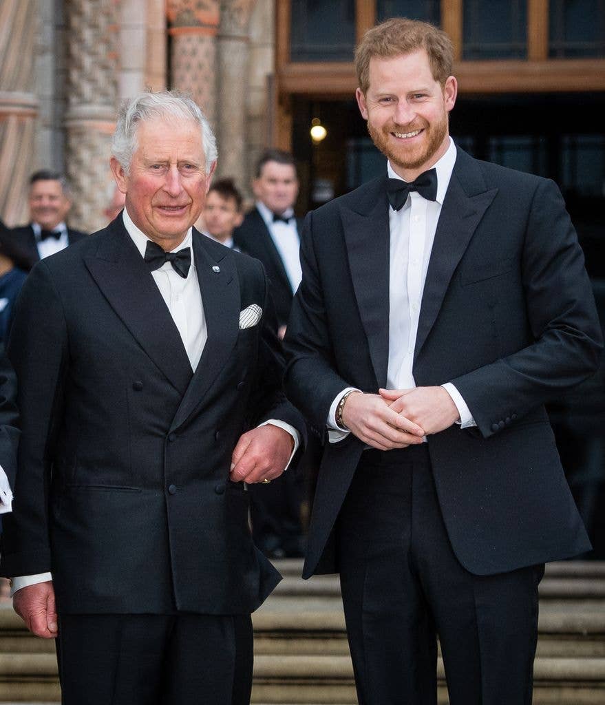 King Charles posing with Prince Harry in tuxedos