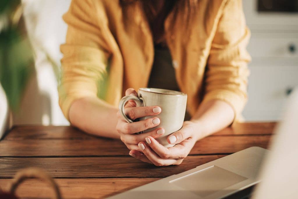 Woman holding coffee cup 