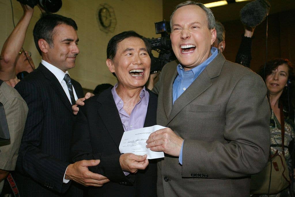 Actor George Takei  (C) and his partner Brad Altman (R) display their document permitting them to get married in West Hollywood, California on June 17, 2008.  Takei, 71, is known to millions of fans as Mr. Sulu from "Star Trek."