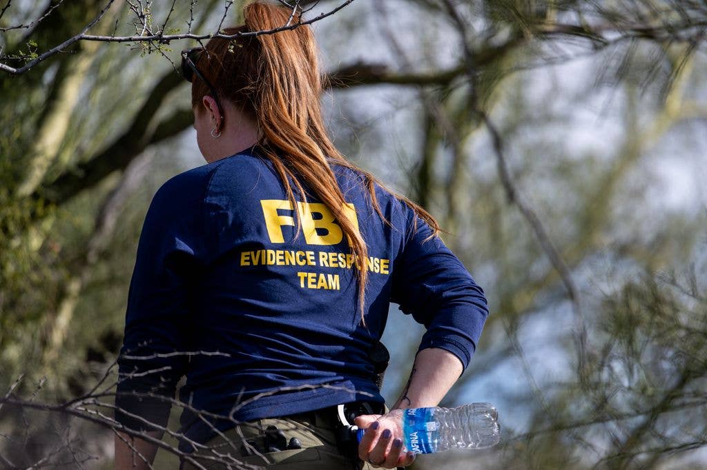 A member of the FBI surveils the area around Nancy Guthrie's residence 