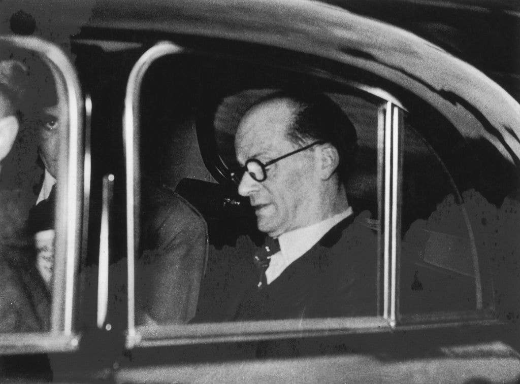 Black-and-white image of John Christie in the back of a car