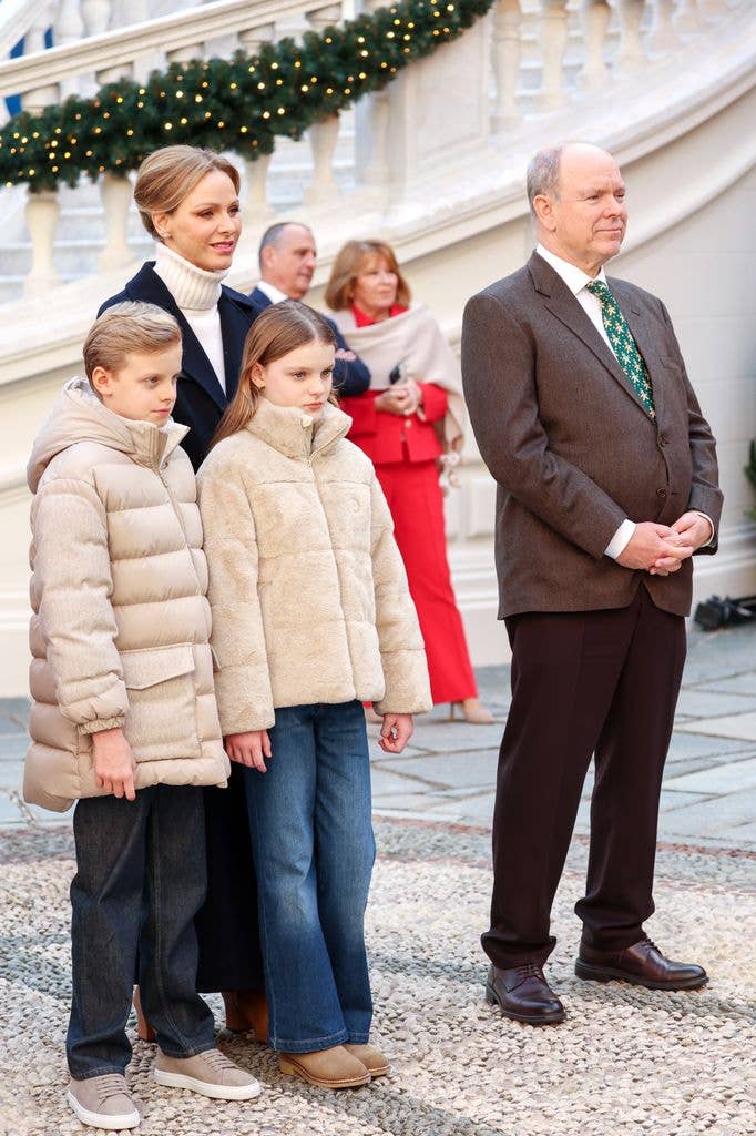 Prince Jacques of Monaco, Princess Charlene of Monaco, Princess Gabriella of Monaco pose in coats outside