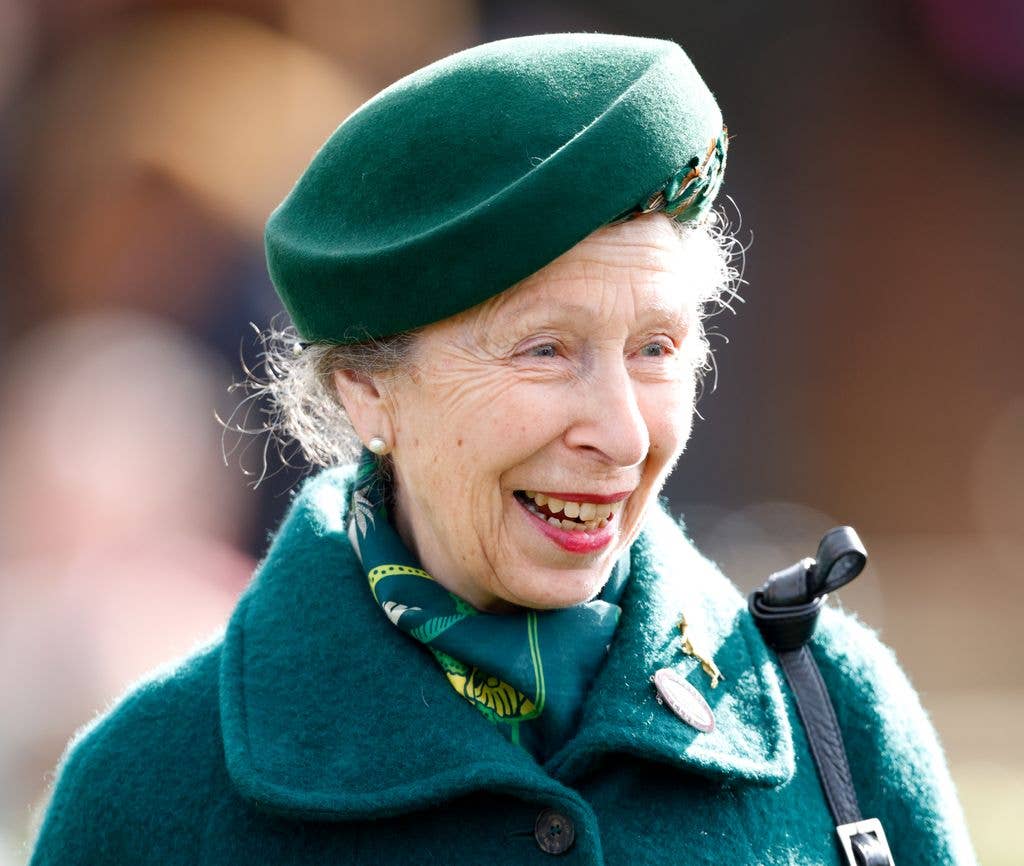 Princess Anne smiling in a green outfit