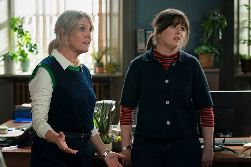 two women standing in office