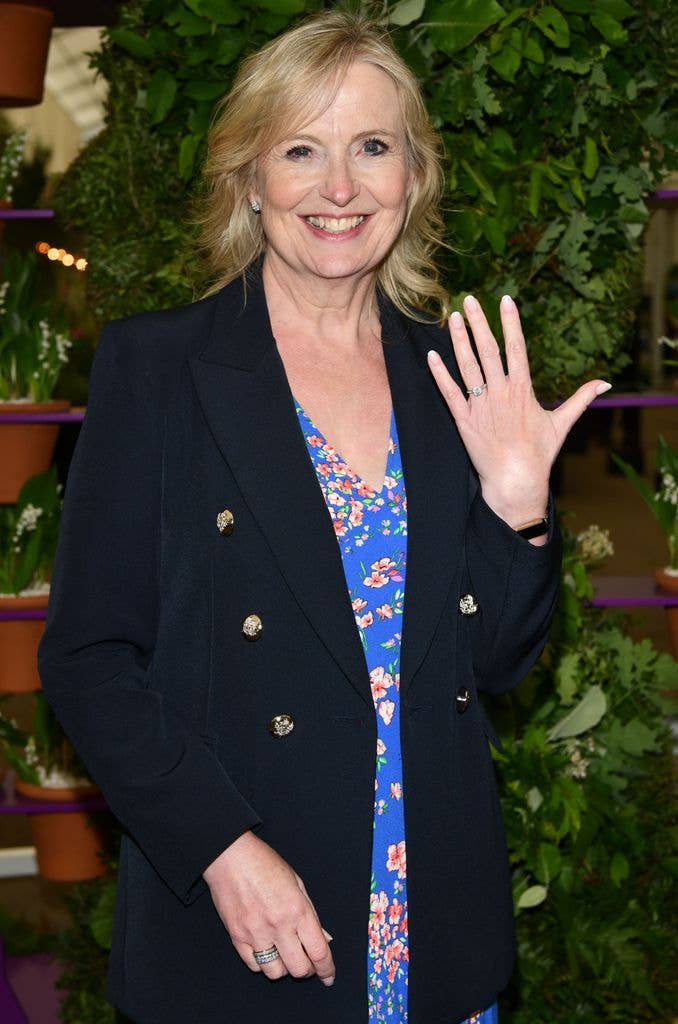 Carol Kirkwood holding up hand and smiling