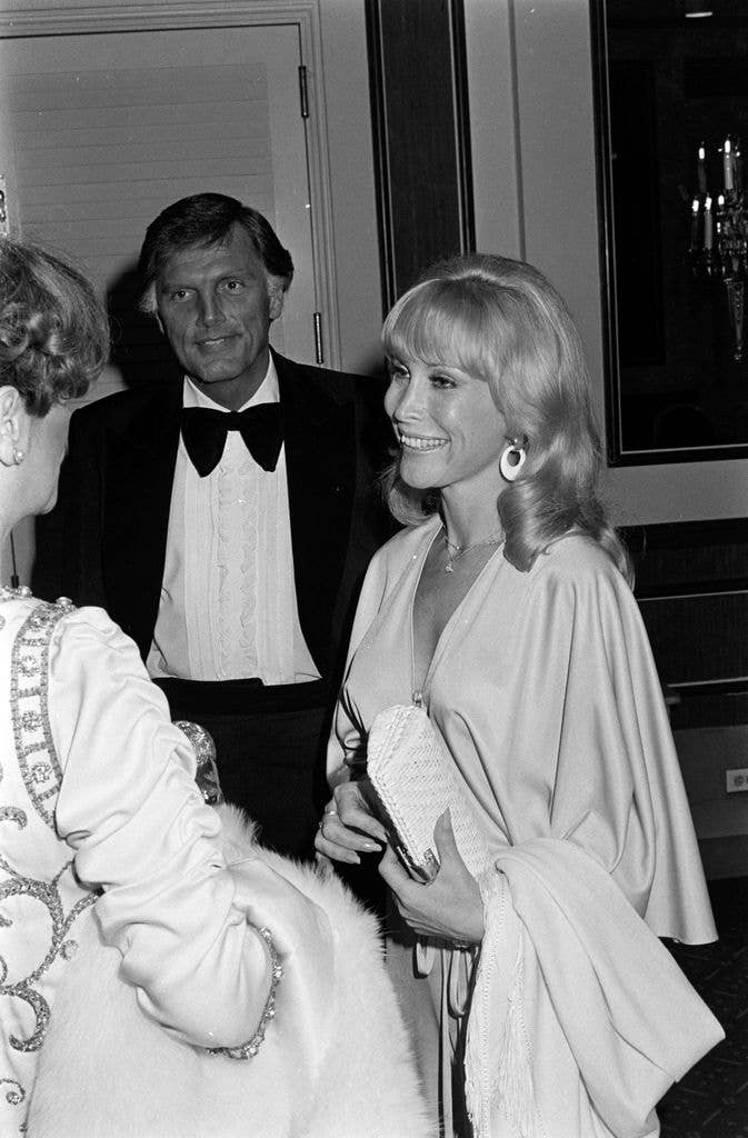 Charles Donald Fegert wears a suit with an oversized bowtie, attending an event at the Lyric Opera with Barbara Windsor who wears a light dress with long butterfly sleeves.