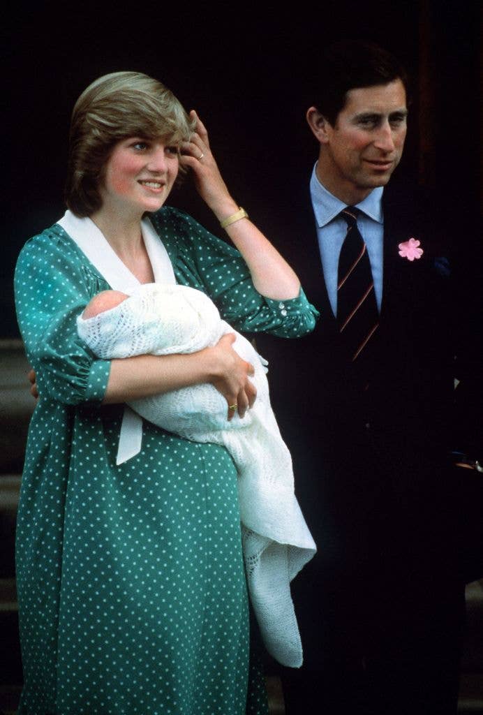 Princess Diana and King Charles holding a baby Prince William outside of a hospital