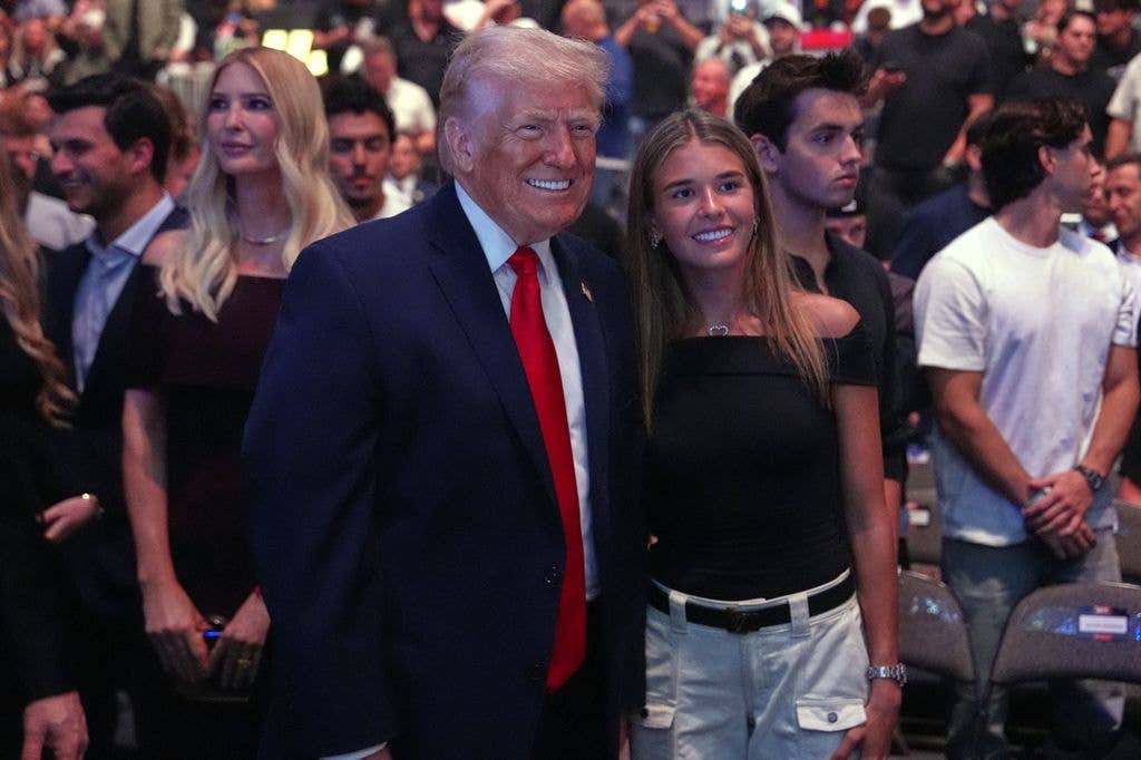 The President posed for a photo with granddaughter Kai Trump