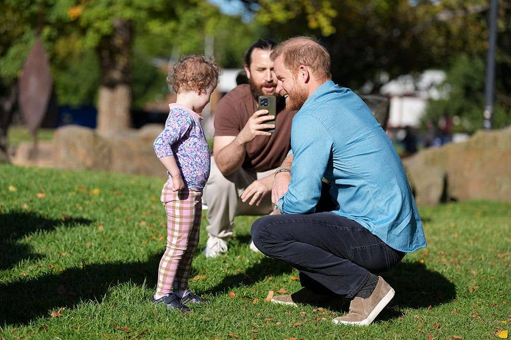 prince harry speaking with child