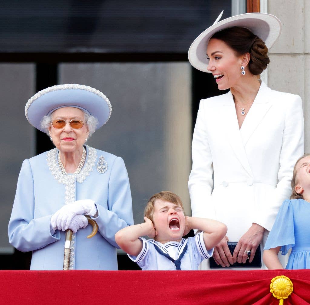 Queen Elizabeth II, Prince Louis of Cambridge and Catherine, Duchess of Cambridge watch a flypast from the balcony of Buckingham Palace during Trooping the Colour on June 2, 2022 in London