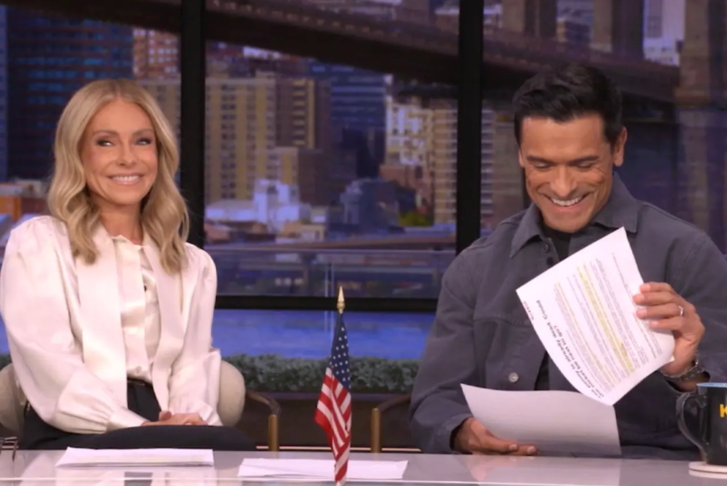 Kelly Ripa in white blouse in studio with Mark in gray shirt