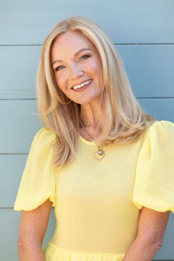 Headshot of poet Donna Ashworth in yellow outfit