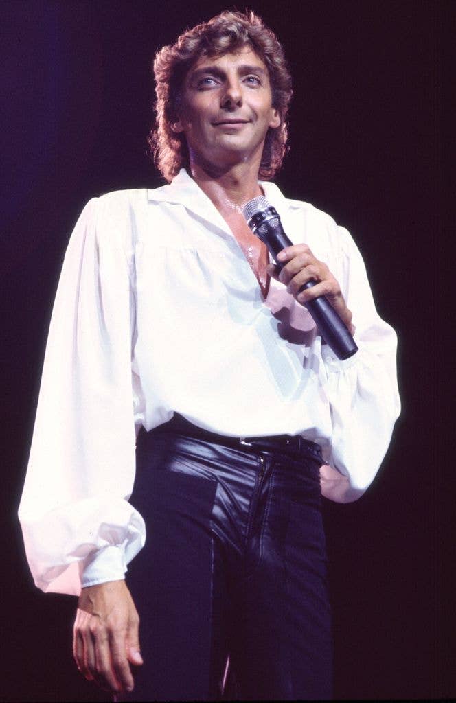 photo of barry manilow holding mic on stage 1984