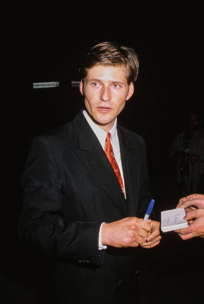 American actor Crispin Glover, wearing a black blazer over a white shirt with a red tie, attends the Universal City premiere of 'Wild at Heart' at the Cineplex Odeon Cinema in the Universal City neighbourhood of Los Angeles, California, 13th August 1990.