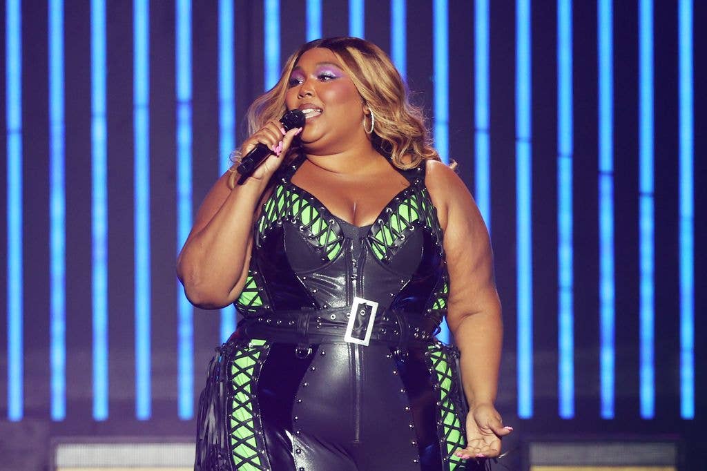  Lizzo performs at Qudos Bank Arena in Sydney wearing black leather catsuit with neon green detailing