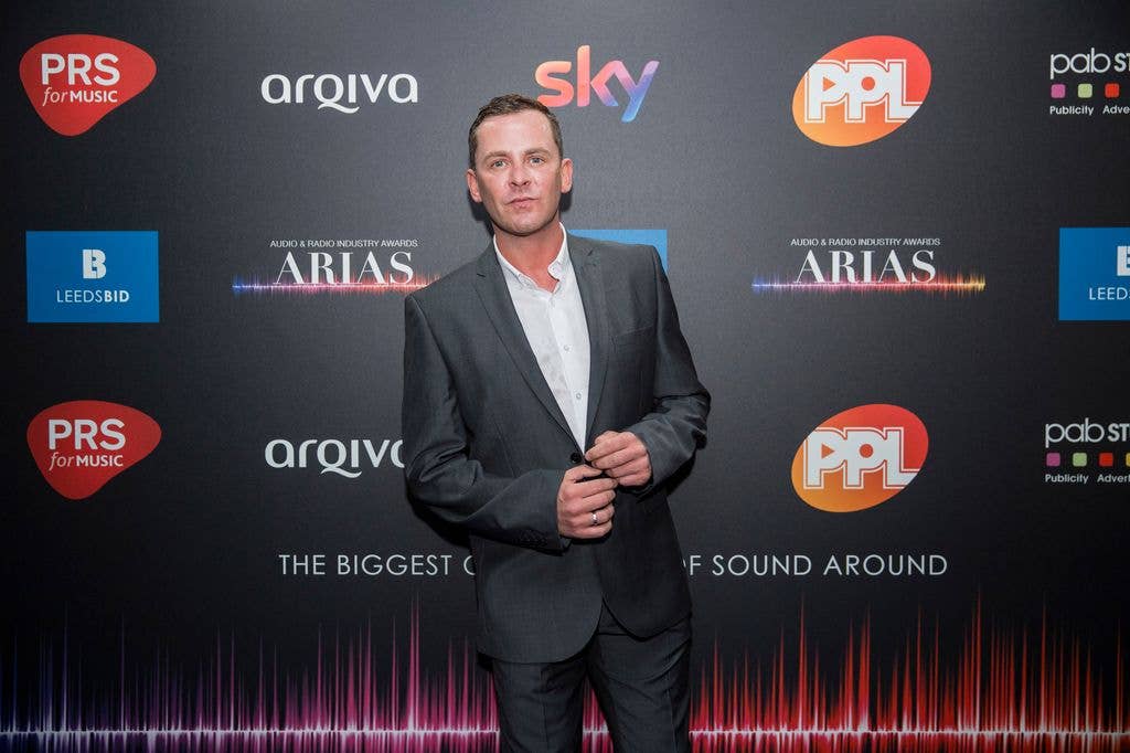 A pphoto of a man wearing a grey suit