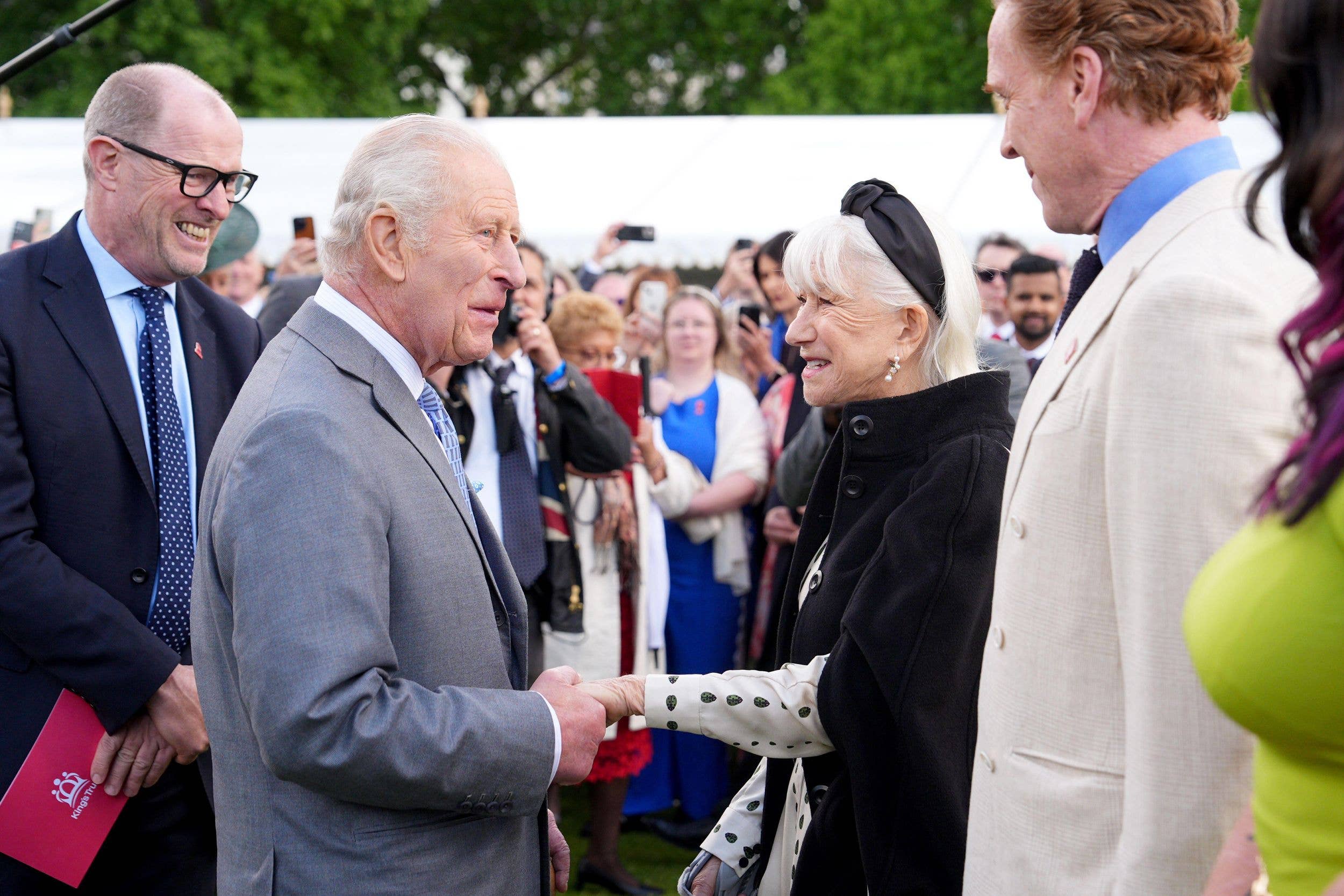 King Charles III greets Helen Mirren during a Royal Garden Party at Buckingham Palace, London, to celebrate the fiftieth anniversary of The King's Trust