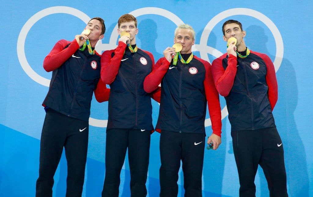 Gold medalist Townley Haas, Conor Dwyer, Ryan Lochte and Michael Phelps of the United States celebrate on the podium during the medal presentation for the Men's 4 x 200m Freestyle Relay Final on Day 4 of the Rio 2016 Olympic Games at the Olympic Aquatics Stadium on August 9, 2016 in Rio de Janeiro, Brazil.