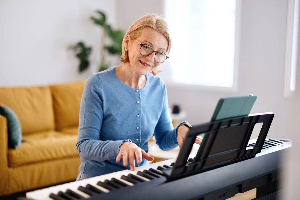 Close-up of a woman playing piano at home