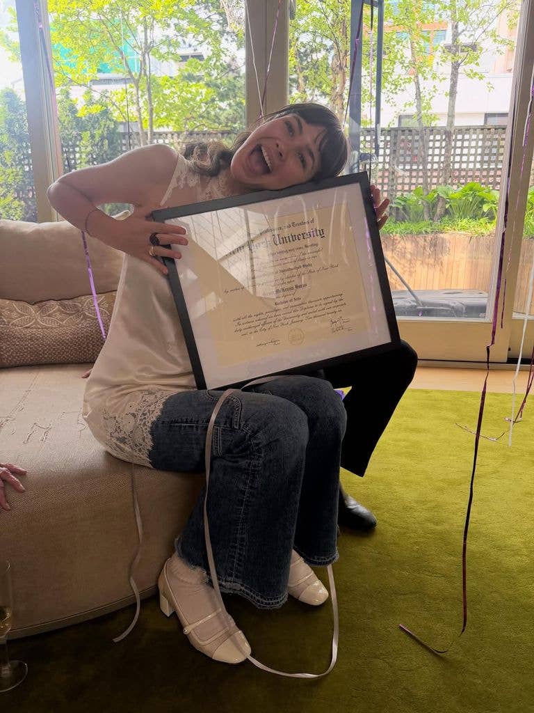 photo of grace burns with graduation diploma