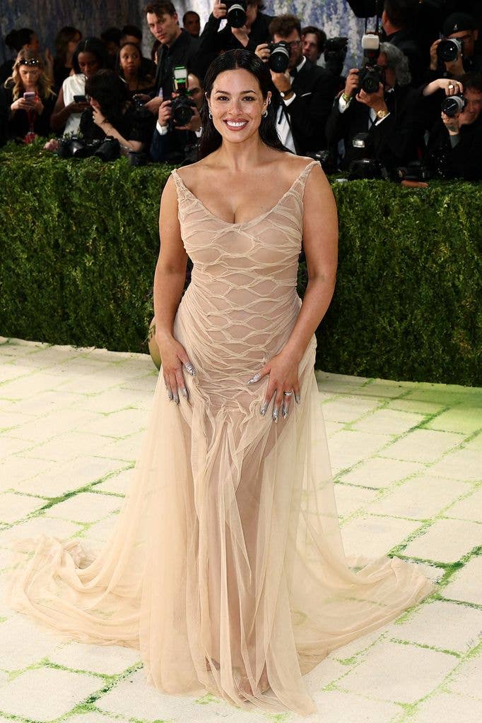 Ashley Graham wearing a cream sheer dress