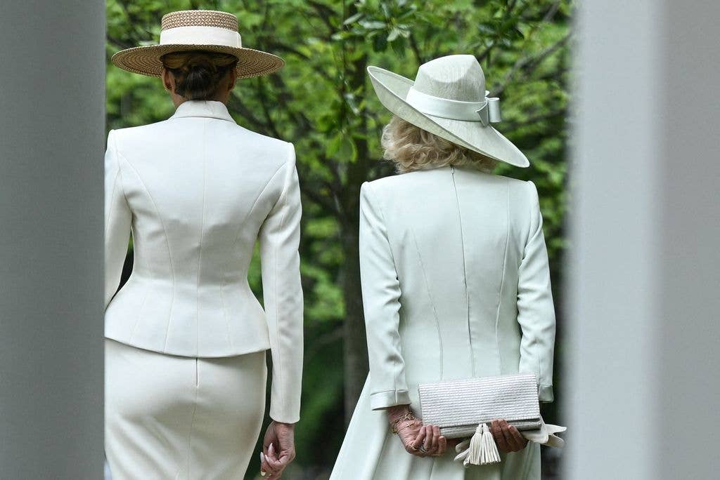 US First Lady Melania Trump (L) and Britain's Queen Camilla walk with each other following an arrival ceremony on the South Lawn of the White House in Washington, DC, on April 28, 2026. 