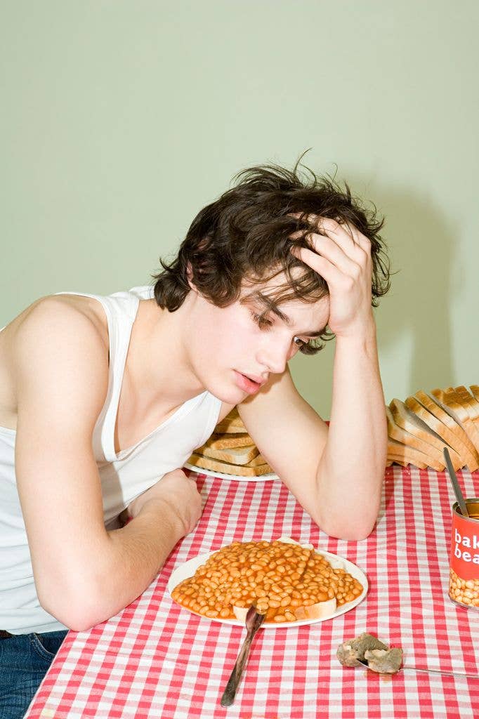 Bored looking student with a plate of beans