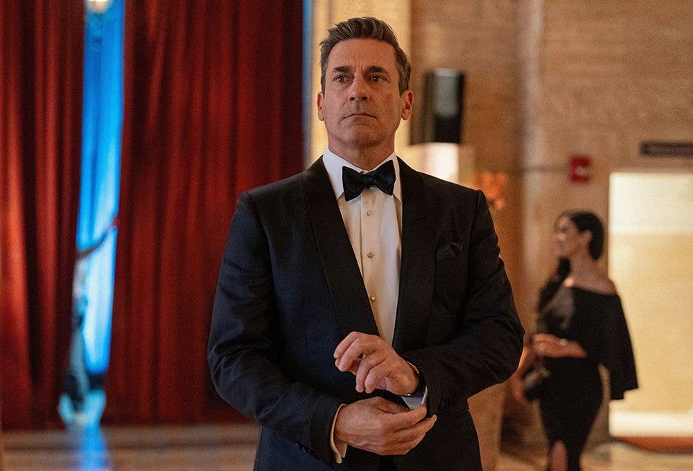 Jon Hamm as Andrew "Coop" Cooper. He is dressed in a tuxedo