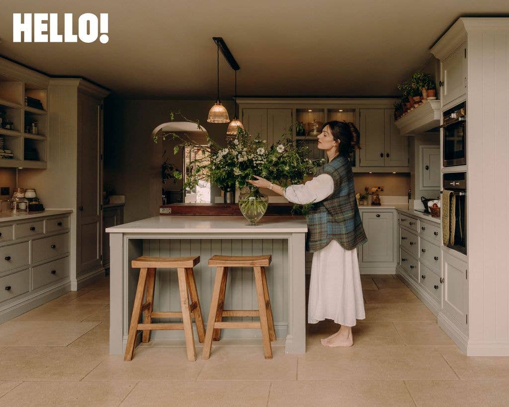 Lydia Millen fixing flowers by the kitchen island inside her home