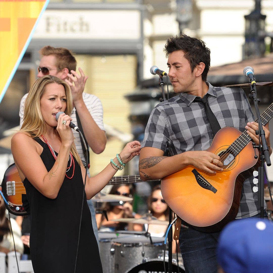Colbie Caillat (L) and Justin Kawika Young perform at Extra at The Grove on July 18, 2011 in Los Angeles, California.