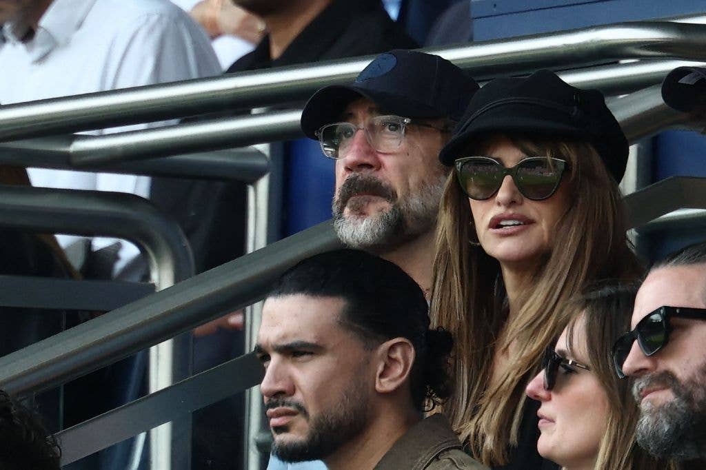 Spanish actor Javier Bardem (L) and Spanish actress Penelope Cruz (R) look on in the stands ahead of the French L1 football match between Paris Saint-Germain (PSG) and FC Lorient at Parc des Princes stadium in Paris on May 2, 2026. 