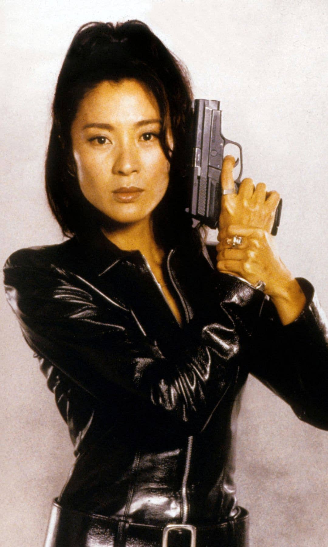Michelle Yeoh in a leather jacket in a promotional image of Tomorrow Never Dies