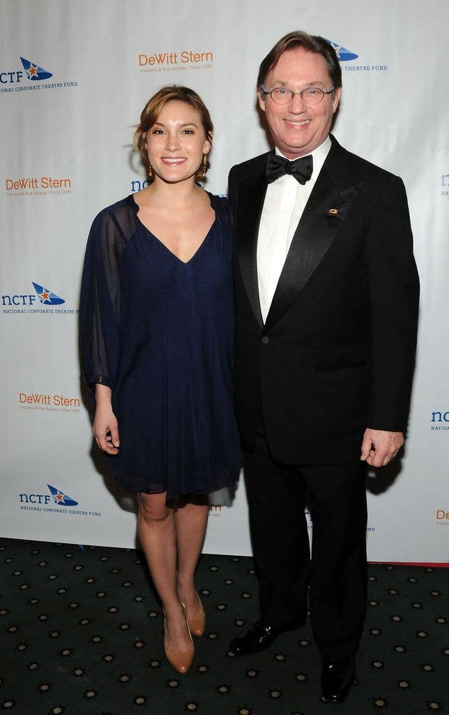 Kendra Thomas in a blue slip with a sheer black overlay standing next to father Richard Thomas in a tux.