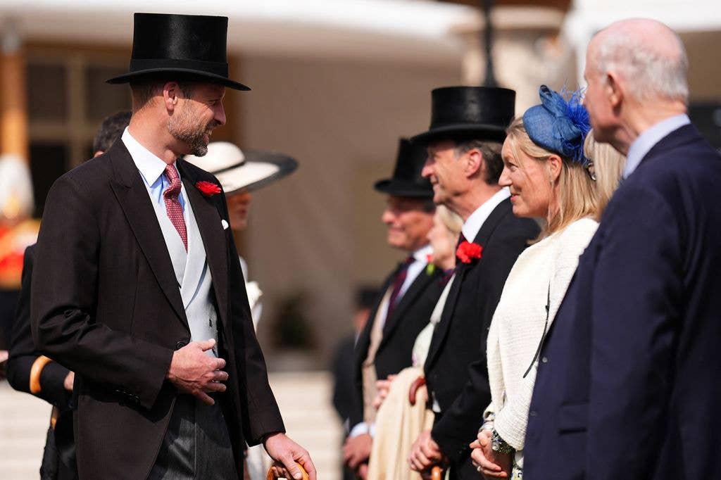 Prince William talk to guests during a Royal Garden Party at Buckingham Palace