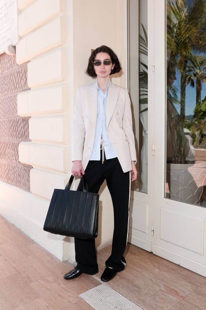 Meadow Walker wears a beige blazer, blue shirt and black trousers