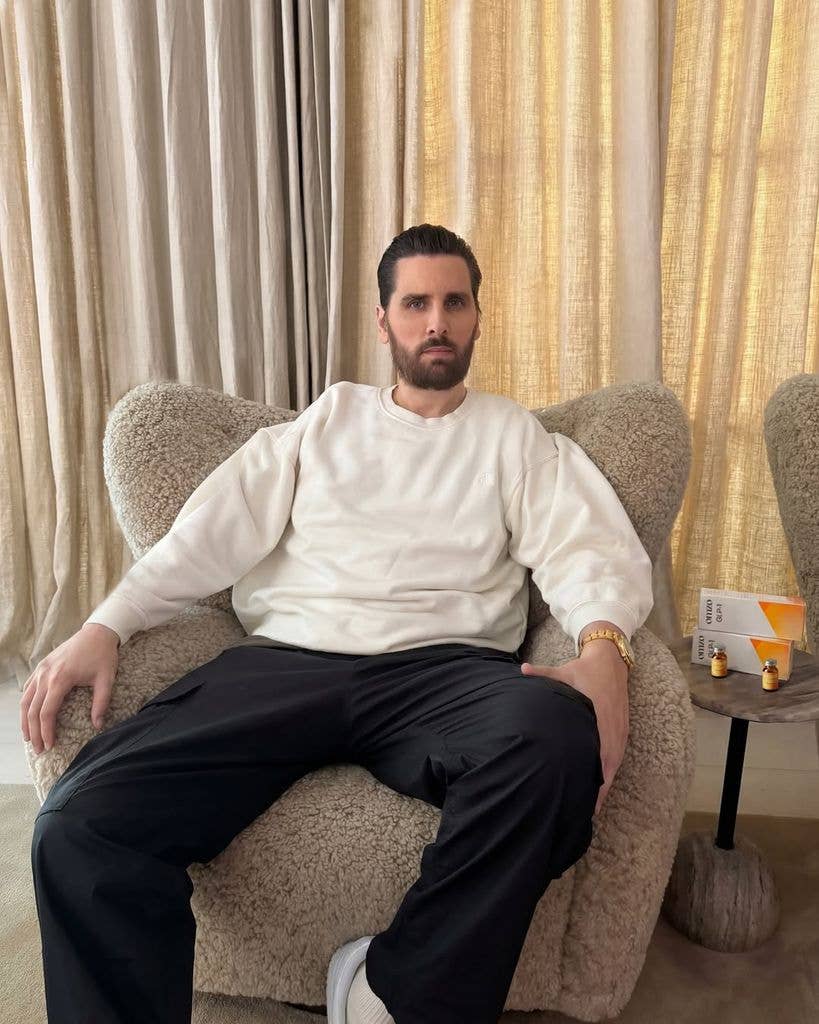 Scott Disick in cream jumper and black pants