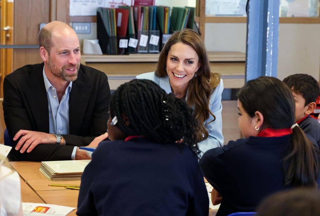 Prince William and Kate Middleton talking to a group of children