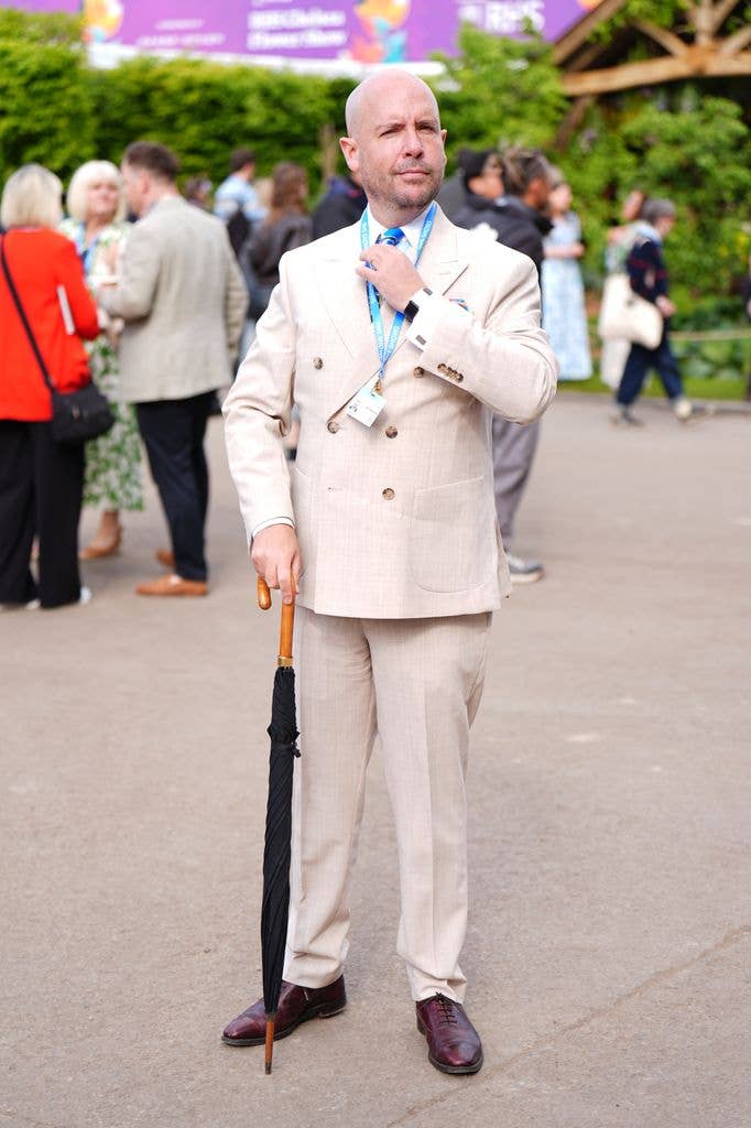 Tom Allen wears a cream double breasted suit and blue shirt