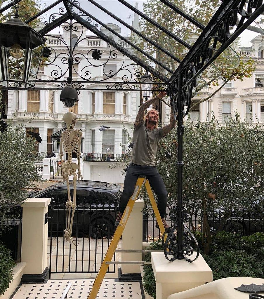 david Beckham outside his home on a ladder