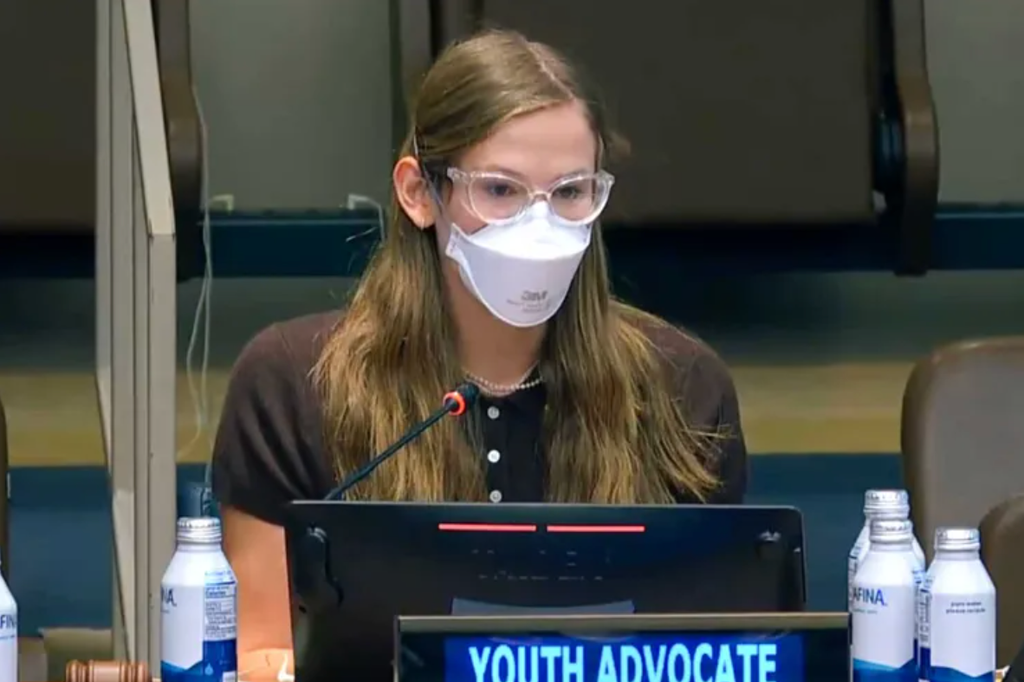 Violet Affleck in brown top wearing mask and glasses