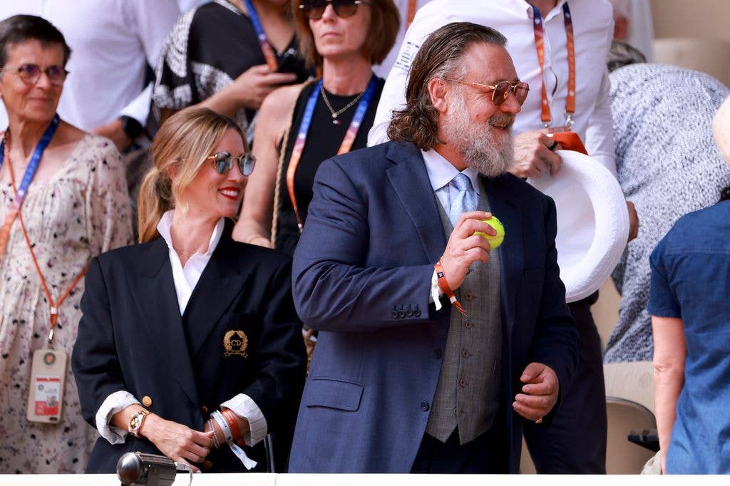 Dressed sharply for the outing, Russell wore a navy suit layered over a grey waistcoat and pale blue tie, while Britney opted for an oversized black blazer with gold crest detailing