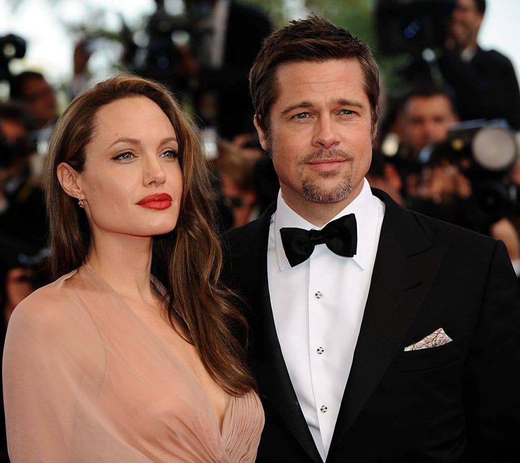 Angelina Jolie in a pale pink dress with Brad Pitt at the Cannes Film Festival in 2009.