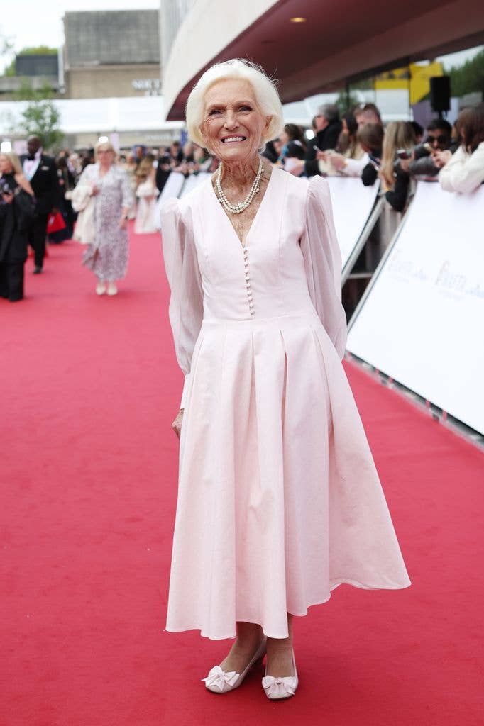 Dame Mary Berry on red carpet in light pink dress