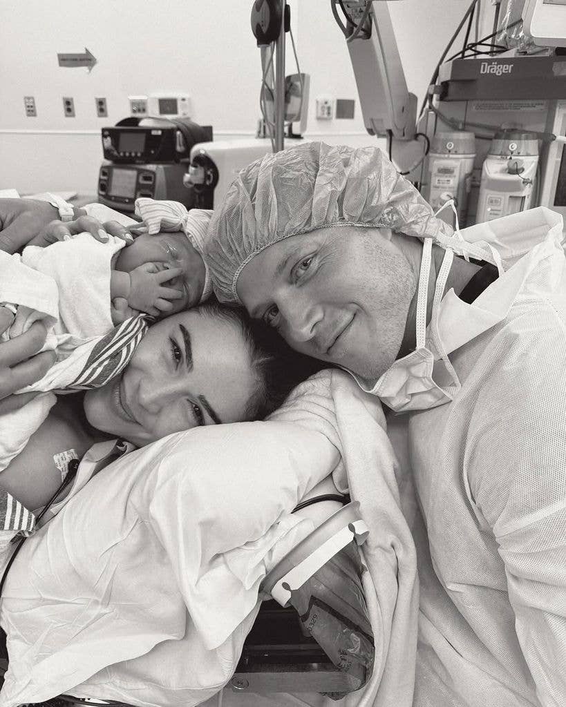 Olivia Culpo and Christian McCaffrey hold their newborn baby girl in a photo captured after labor at the hospital, shared on Instagram
