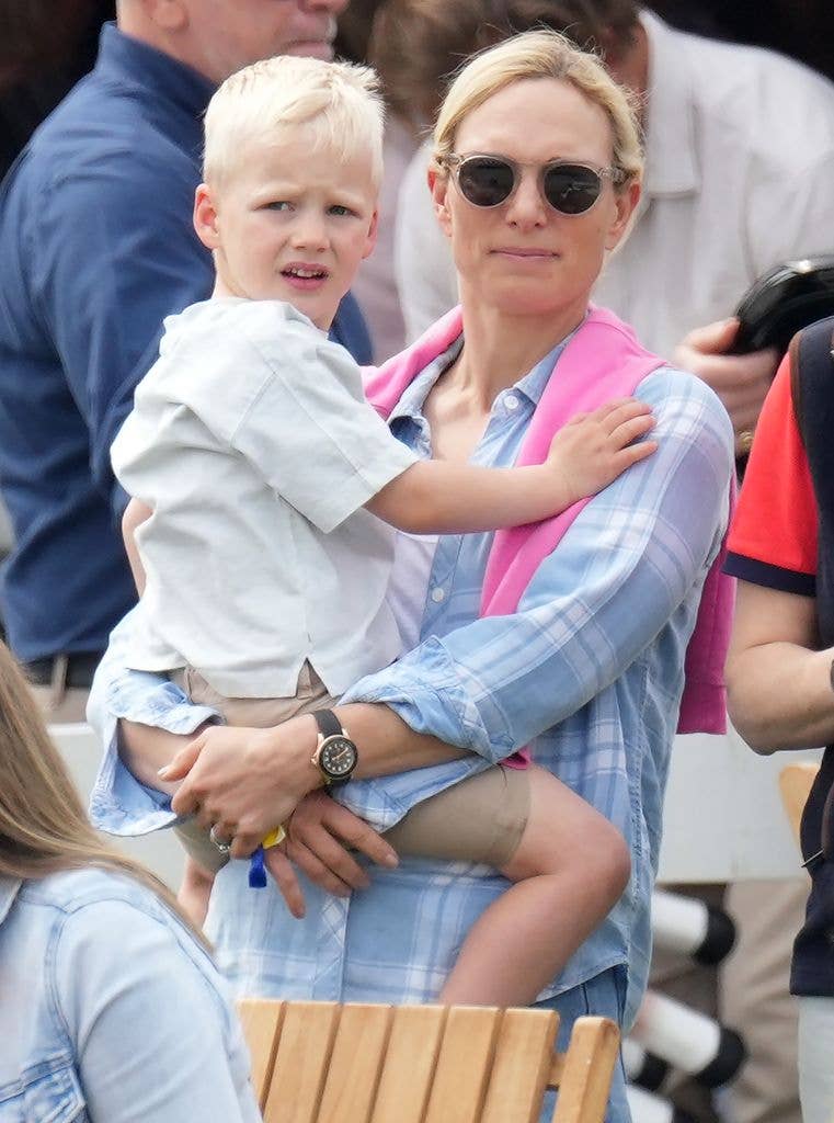 Zara holding son Lucas Tindall on hip