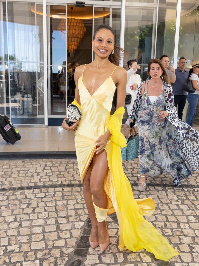 Emma Weymouth wears a pale yellow slip dress with bright yellow scarf