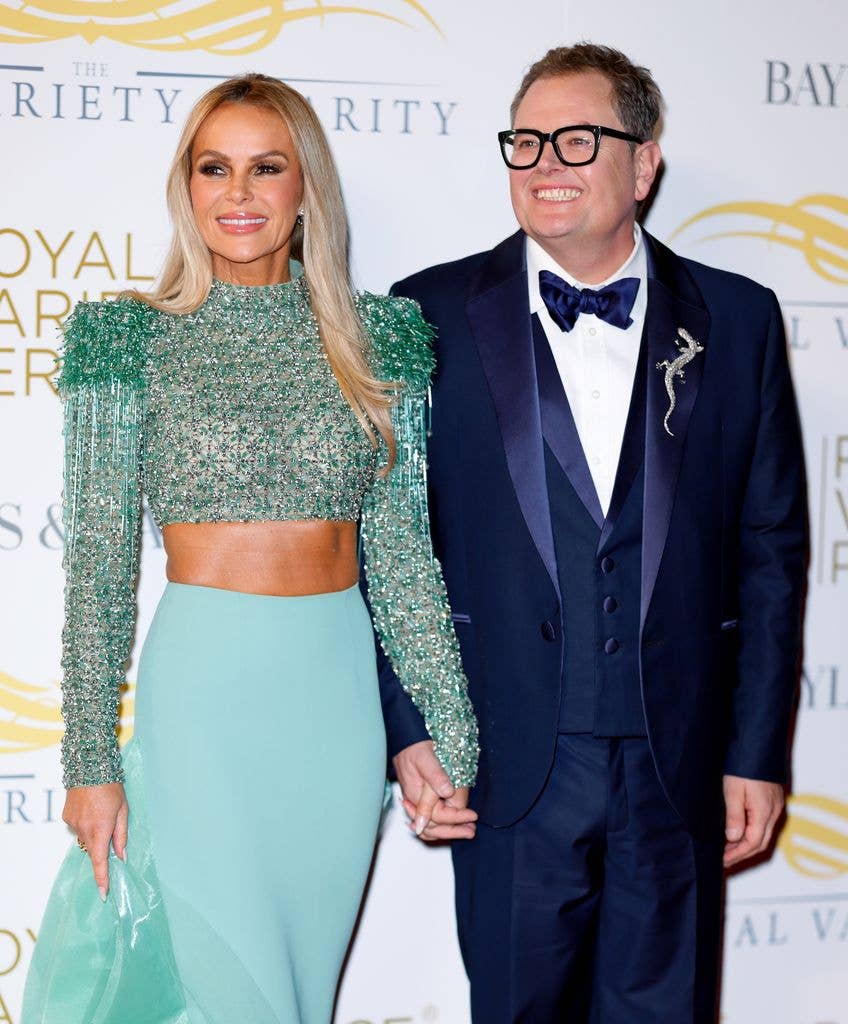 Amanda Holden and Alan Carr standing hand in hand