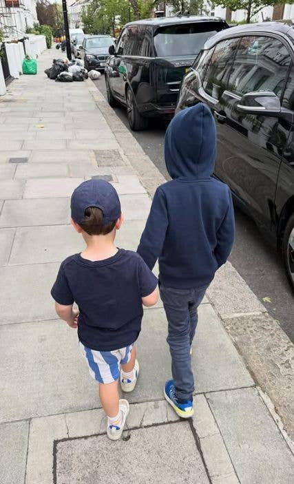 Two young boys walkinf down a path