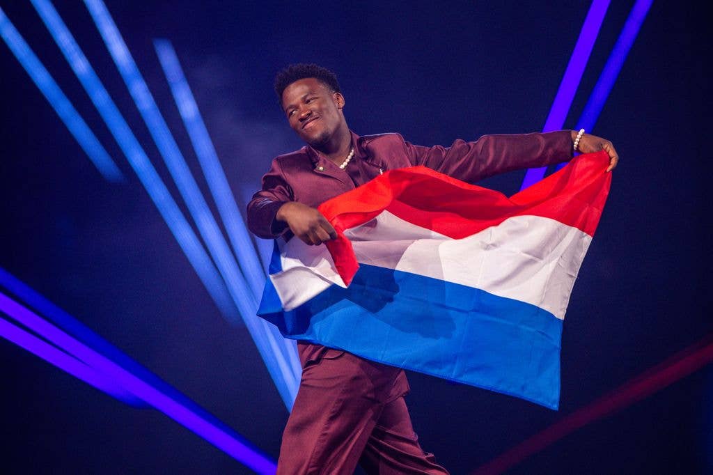 16 May 2025, Switzerland, Basel: Claude from the Netherlands runs onto the stage with the flag during a rehearsal for the final show of the 69th Eurovision Song Contest in the Arena St. Jakobshalle